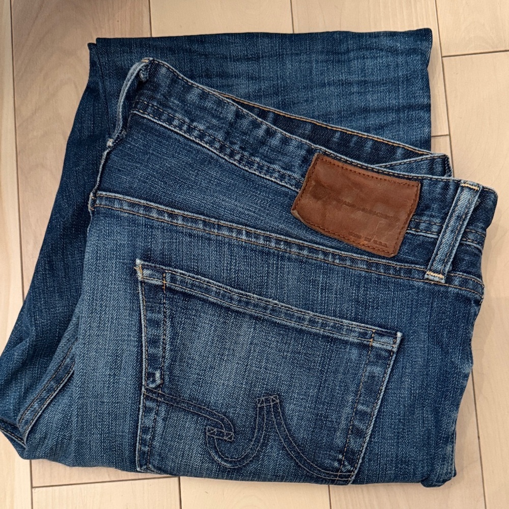 Ag Adriano Goldschmied Men’s Straight Jeans in Medium Dark Blue with Brown Patch